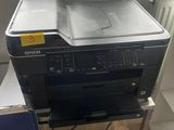 a printer sitting on top of a desk next to a box