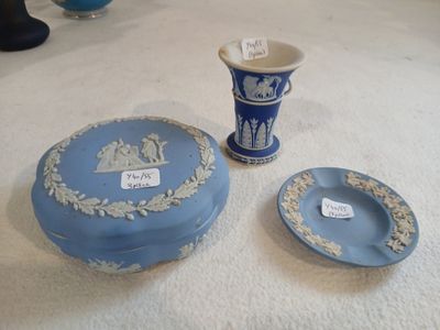 two blue and white vases and a plate on the floor