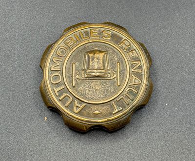 a close up of a gold colored badge on a gray surface