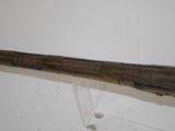 a close up of a wooden stick on a stand on a white surface