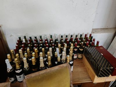 many bottles of wine sitting on a table next to a box