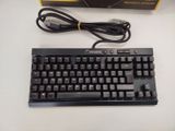 a black keyboard and a charger sitting on a table