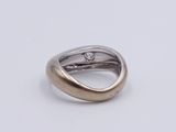 a close up of a silver ring with a diamond on it