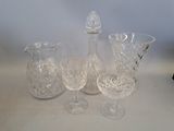 three glass vases and a small vase on a table