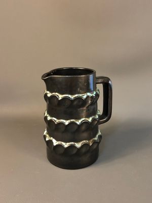 a picture of a black and white pitcher on a table