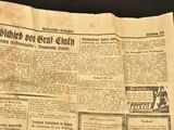 newspapers are being displayed on a table with a black background