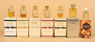 several bottles of different types of perfume sitting next to each other