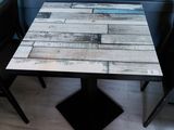 a table that has a wooden table top on it