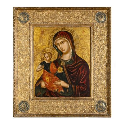 un tableau représentant une femme tenant un enfant dans un cadre en or