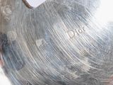 a person holding a silver plate with a sticker on it