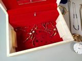 a red box with a bunch of jewelry inside of it