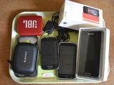 a tray with cell phones and a charger on it