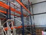 many shelves in a warehouse with various items on them