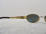 sunglasses on a white surface with a white wall in the background