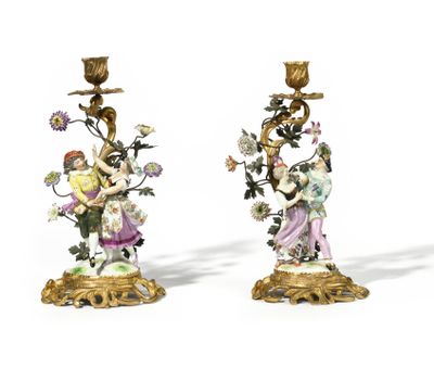 pair of antique porcelain candlesticks with figures and flowers