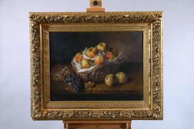 painting of a basket of fruit on an easel with grapes and peaches