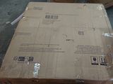 a cardboard box sitting on top of a carton on the floor