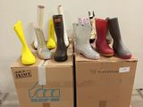 several pairs of rain boots are stacked on top of a cardboard box