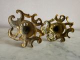 pair of antique brass candlesticks on a marble table