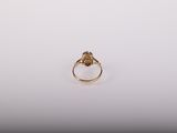 a close up of a gold ring on a white surface