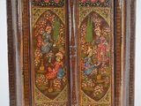 a wooden cabinet that has a painting on it