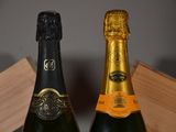 two bottles of champagne sitting next to each other on a table