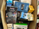 a cardboard box full of electronics and other items