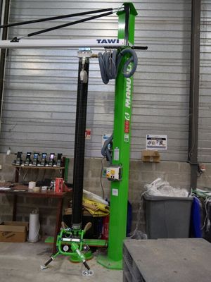 a picture of a green lift in a warehouse