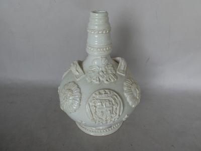 a white vase with a design on it on a table