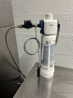 an image of a water filtrator on a stainless steel table