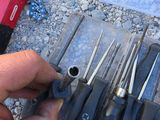 a man that is holding a bunch of tools in his hand