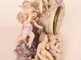 figurines of cherensils and cherensils are sitting on a clock