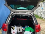 the back of a car with its trunk open with a bunch of items in the trunk