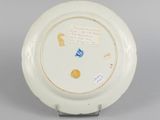 underside view of a white plate with a blue and yellow design