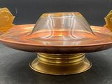 a glass bowl with two fish on it on a table