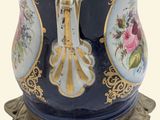 a blue vase with a gold decoration on it