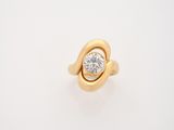 a gold ring with a diamond set in the center