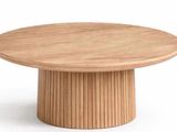 the table is made of wood and has a round base