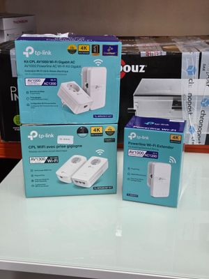 two boxes of wii remotes sitting on a table in a store