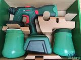 a green box with tools in it on a table
