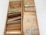 a wooden box filled with assorted papers on a white surface