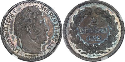 a close up of a coin on a white surface