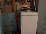 a refrigerator and a refrigerator freezer in a small room