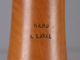 a close up of a wooden vase with writing on it
