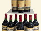 bottles of red wine are stacked on a shelf in front of a white background