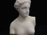 marble bust of a woman on a black background with a black background