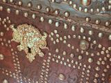 a close up of a metal box with gold decorations on it