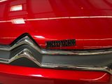 a close up of a red car with a logo on it