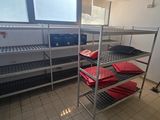 a room that has a lot of shelves with red bags on them