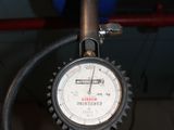 a close up of a gauge on the side of a pipe